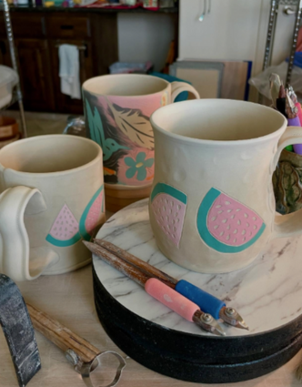 Tall handbuilt double vase with botanical carved patterns and textured green glaze, featuring interior aqua blue lining. Created using DiamondCore tools.