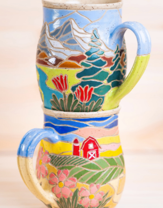 Speckled ceramic planter with carved and painted coastal motifs including a turtle, starfish, and coral, part of the artist's Coastal Collection.