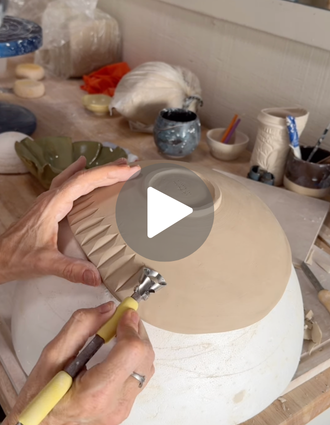 Artist carving bold, angled textures into the side of a large clay bowl using a yellow-handled DiamondCore® trimming tool.