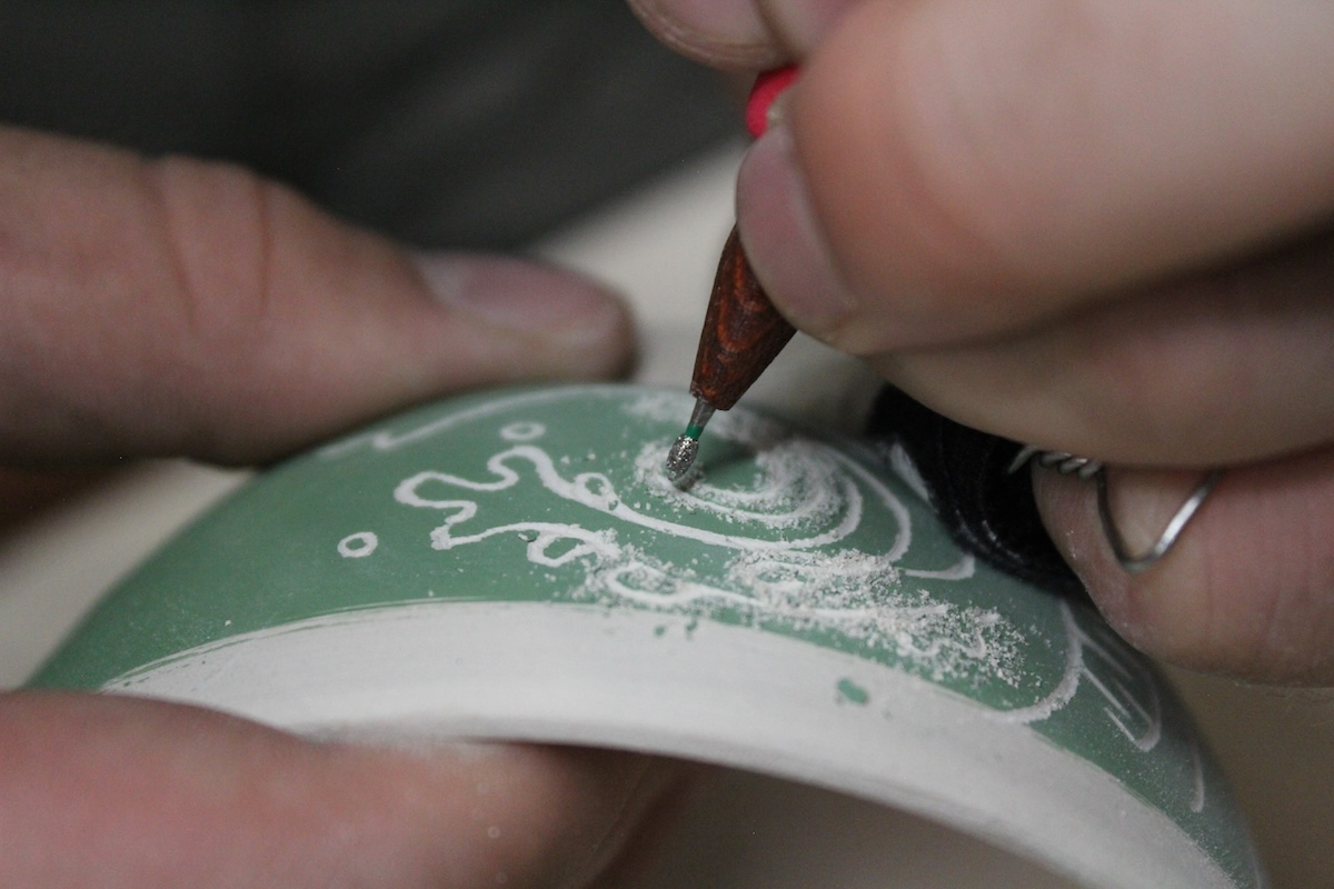 An artist carving a bowl.